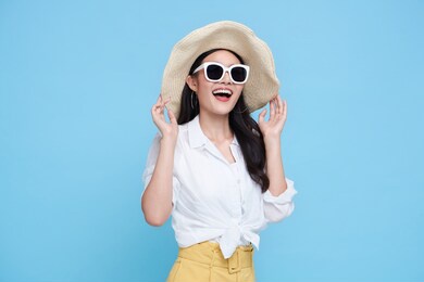 happy asian woman in summer casual clothes isolated on blue backgroud.