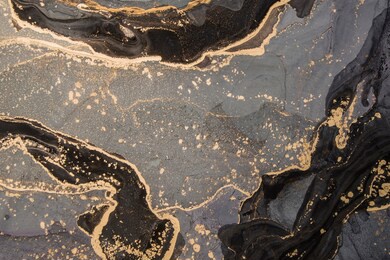 high resolution. luxury abstract fluid art painting in alcohol ink technique, mixture of black, gray and gold paints.  imitation of marble stone cut, glowing golden veins. tender and dreamy design. 
