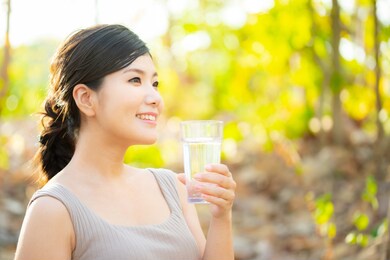 a japanese woman with a glass of water