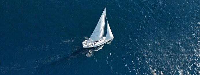 aerial drone photo of beautiful sailboat cruising deep blue open ocean mediterranean sea