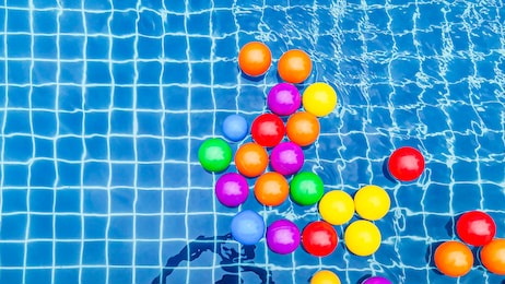 many small colorful plastic balls in the pool.