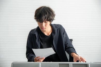 young man composing a song in music studio