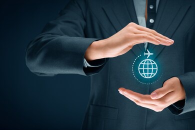 travel insurance and business travel concepts. insurance agent or businessman with protective gesture and icon of plane and globe.