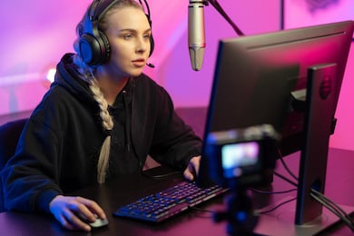 professional e-sport gamer girl streaming and plays online video game on pc