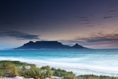 table mountain from milnerton beach with grass in the foreground