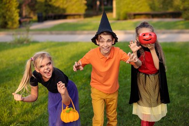 happy children in the park in halloween costumes celebrate the holiday