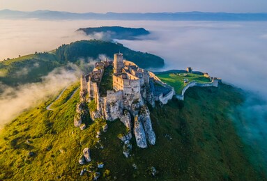 aerial panoramic views of the spiš castle, slovakia, in the morning sunlight with foggy background