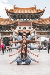 group shot action of asian friendship over the kunming jinbi square, kunming, china, travel and tourism with friend ship, dancing and parody cover concept,chinese text is golden horse and jade rooster