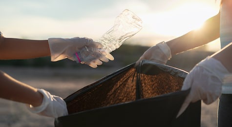group of kids school volunteer charity environment, improving environment. kind eco-friendly volunteers holding packets and gathering garbage
