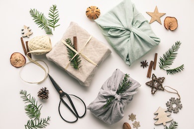 fabric wrapped gifts and wooden christmas decorations