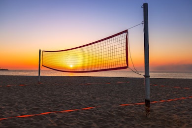 volleyball net and beautiful sunrise on the beach 