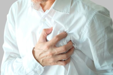 heart attack, man standing chest pain in the bedroom health concept.