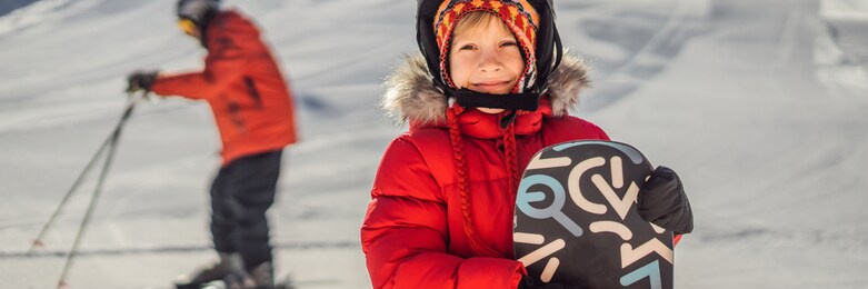 little cute boy is ready for snowboarding. activities for children in winter. children's winter sport. lifestyle banner, long format