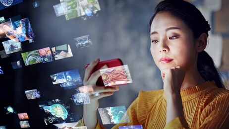 young asian woman watching a lot of movies. digital transformation.