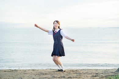 asian female high school student in a cheering pose