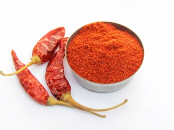 dry chili pepper and chili powder on a white background