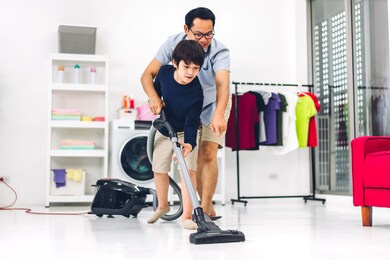 father teaching asian kid little boy son having fun doing household chores cleaning and washing floor wiping dust with vacuum cleaner while cleaning house together at home.housework concept