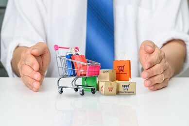 consumer rights and consumer protection, business law concept : buyer or purchaser protects bags and boxes of goods purchased online from internet retailer website, depicts caring on products bought