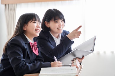 a japanese junior high school girl is taught by her teacher in the classroom