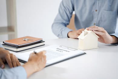 real estate agent meeting customer with insurance policy about house contract.