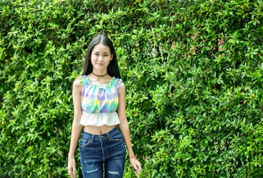 portrait of happy smiling woman standing on sunny summer or spring day outside, cute smiling woman looking at you, attractive young girl enjoying summer.