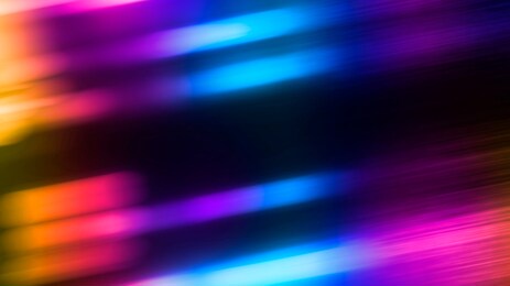 multi-colored neon lights on a dark city street, reflection of neon light in puddles and water. abstract night background, blurred bokeh light. night view.