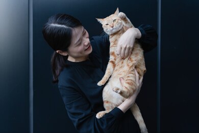 happy woman hugging her cat