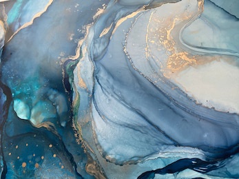 abstract blue background with beautiful smudges and stains made with alcohol ink and gold pigment. blue colored fragment with texture resembles watercolor or aquarelle painting.