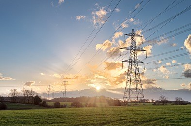 electricity pylon - uk standard overhead power line transmission tower at sunset.