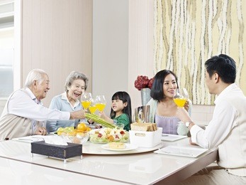 three-generation family having meal at home