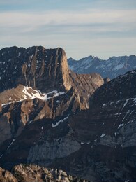 some mountains in switzerland with a bit of snow