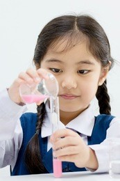 asian student doing a science experiment.