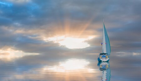 sailing yacht from sail regatta on mediterranean sea at sunset - sailing luxury yacht with white sails in the sea.