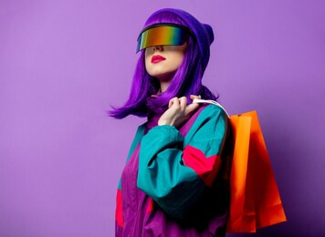 style woman in vr glasses and 80s tracksuit with shopping bags on violet background