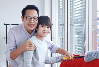 asian father and son cleaning house on vacation.
concept happy holiday life