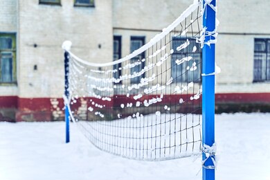 the volleyball net was not removed for the winter, it was covered with snow.