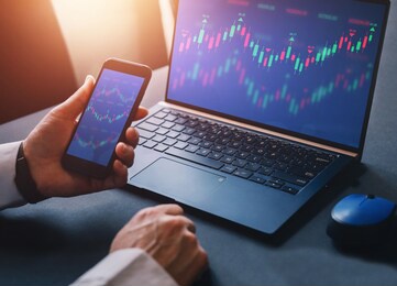 business woman using  laptop computer with financial graphs and statistics on monitor. forex investment business. 
