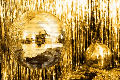 festive background. disco ball on beige and fortuna gold background. christmas. wedding. birthday. color of the year.