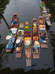 peoples sell agriculture fruit and food on wooden boat at damnoen saduak floating market is popular tourist attraction on canals of thailand.