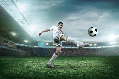soccer player with ball in action outdoors.