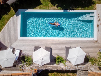 two person swim in the pool at the hotel. view from above, couple men and women in swimming pool of luxury vacation home in the ardeche france europe