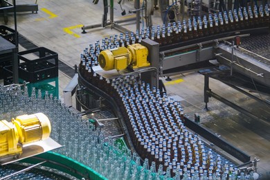 modern automated beer bottling production line. beer bottles moving on conveyor