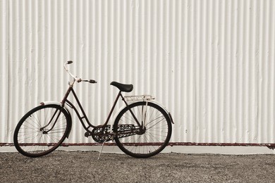 rusted bike on a metallic wall. horizontal.