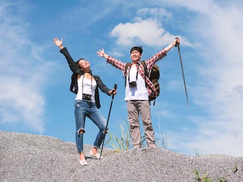 portrait asian young men and women relax breath of natural fresh air. enjoy your trip hiking trekking pole travel.
