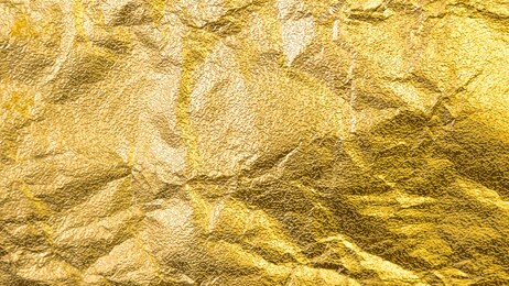 wrinkled gold foil leaf gradation shiny with sparkle yellow metallic texture background.
abstract crumpled paper glitter golden glossy for template.
top view.
