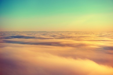 amazing view from plane on the orange sky, sunset sun and clouds