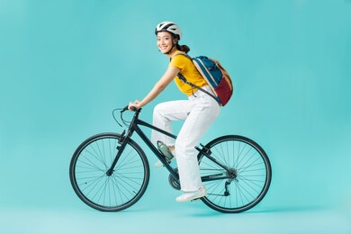 asian beautiful woman, she is riding a city bike to work.she is looking