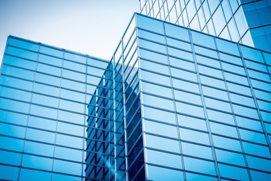 upward view of modern glass skyscraper,exterior of glass wall of an office building 