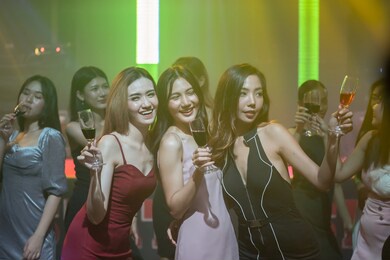 party with friends dancing in the club. asian event holidays celebrate nightlife. group of young girl happy dancing party hand holding a drink. lifestyle women young asian enjoyment nightclub.