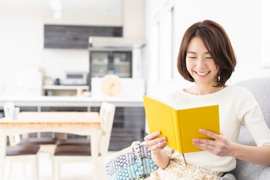 young attractive asian woman who reads a book